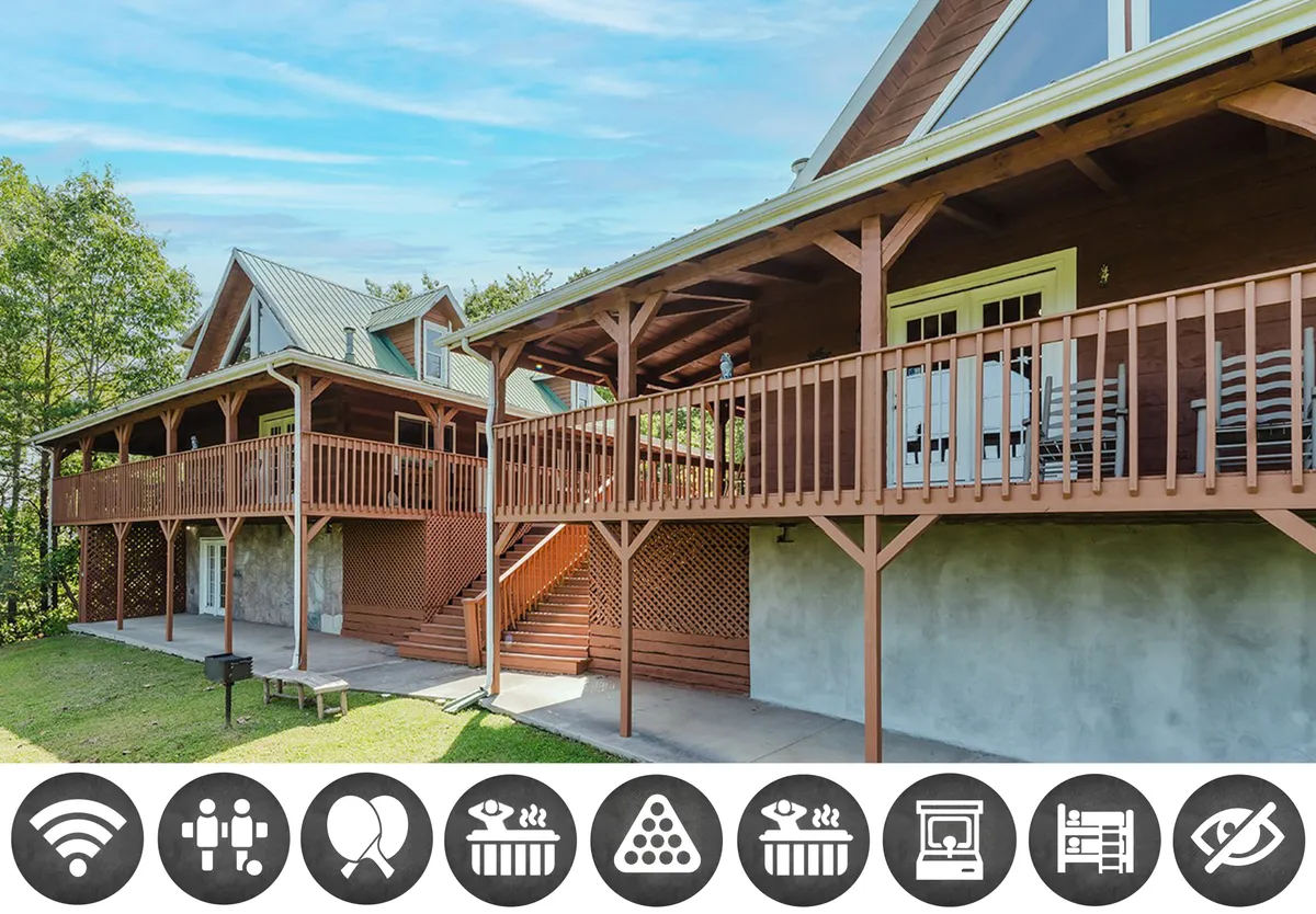 The image captures the exterior of a spacious wooden cabin set against lush greenery, with inviting balconies overlooking the mountains. The scene is suffused with the warm glow of sunset, hinting at cozy evenings spent outdoors and moments of relaxation with family or friends on the expansive decks.